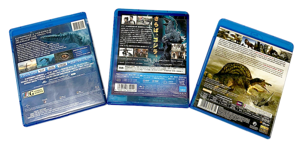 Three dinosaur Blu-ray cases showing detailed cover art and information on prehistoric creatures.