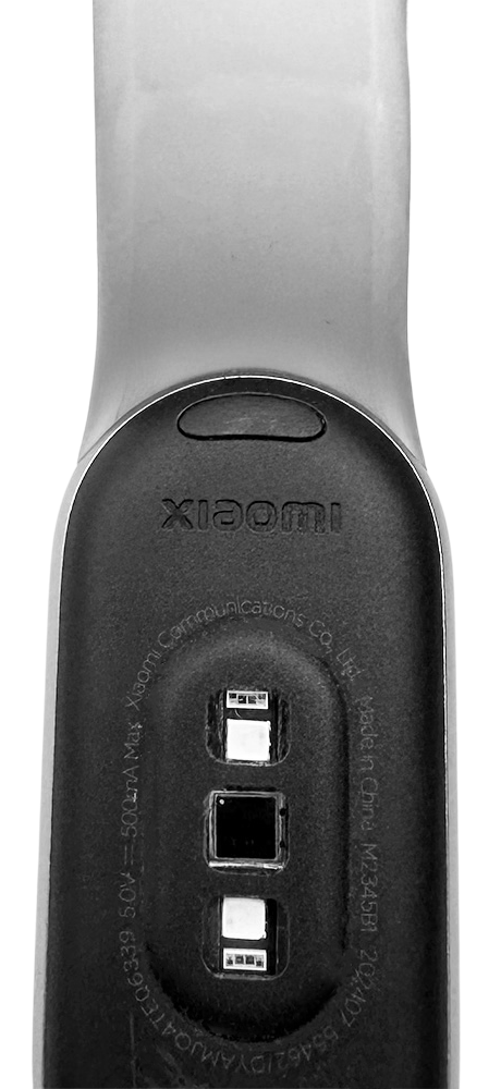 Close-up of the sensor and strap on the back side of a Xiaomi Smart Band 9 fitness tracker.