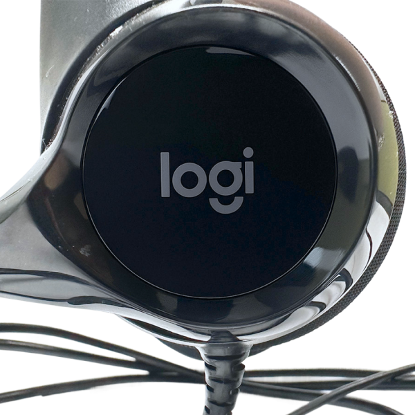 Close-up of the Logitech H390 gaming headset earcup, featuring "logi" branding and wired connection.