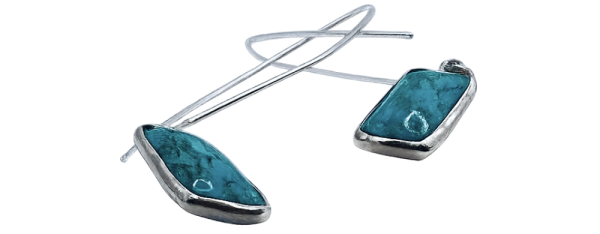 Silver drop earrings with turquoise stones, modern design jewelry accessory showcased on white background.