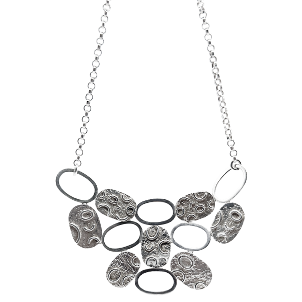 Silver disc necklace with textured circular and oval links, perfect for adding elegance to silver necklaces collections.